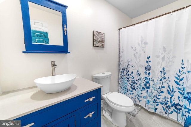 full bath featuring toilet, tile patterned flooring, and vanity