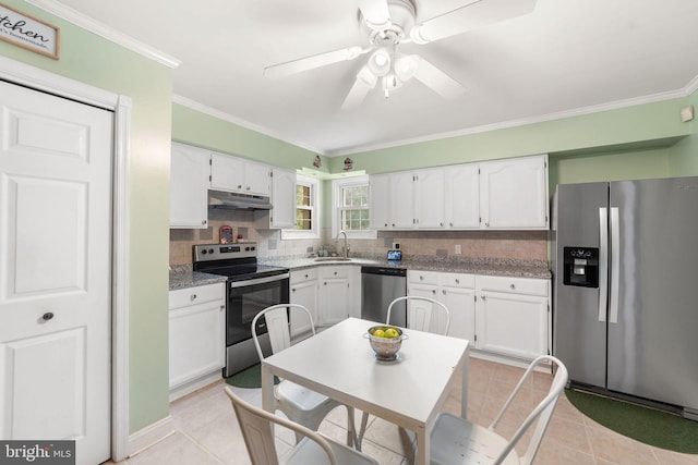 kitchen with light tile patterned floors, under cabinet range hood, white cabinets, appliances with stainless steel finishes, and backsplash