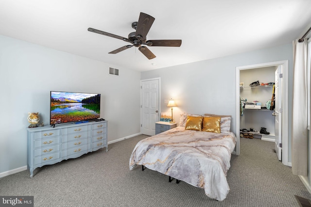 bedroom featuring visible vents, baseboards, light colored carpet, ceiling fan, and a spacious closet