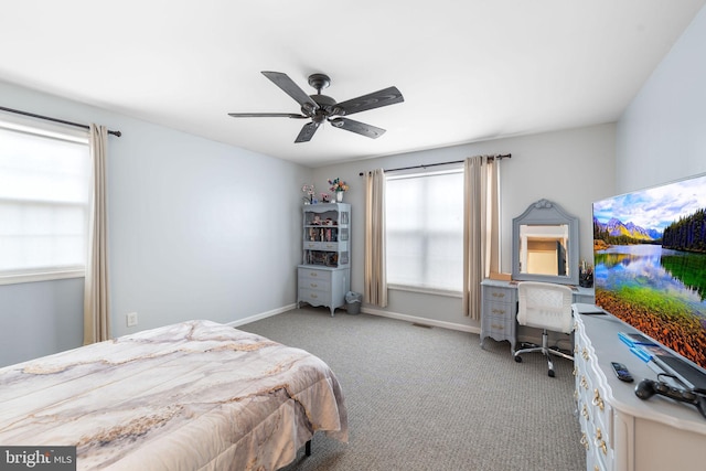 bedroom with light carpet, ceiling fan, visible vents, and baseboards