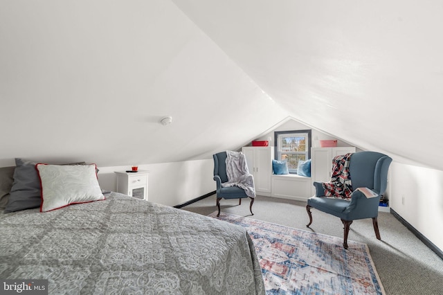 carpeted bedroom with baseboards and vaulted ceiling