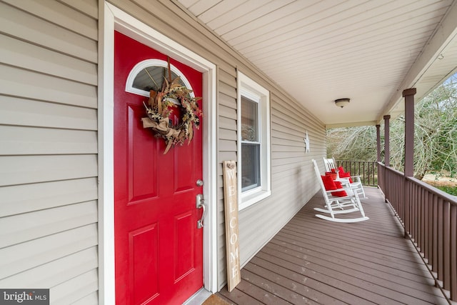 view of exterior entry featuring covered porch