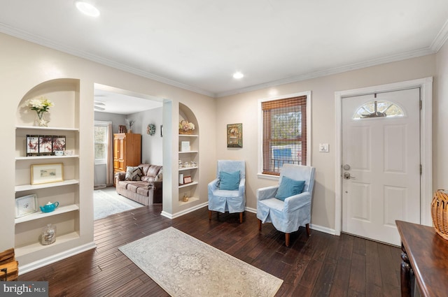 foyer entrance featuring crown molding, baseboards, and dark wood-style flooring