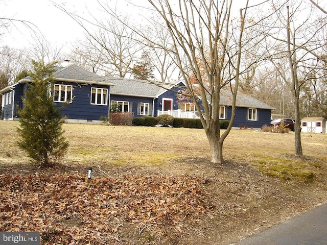 ranch-style home with a shingled roof and crawl space