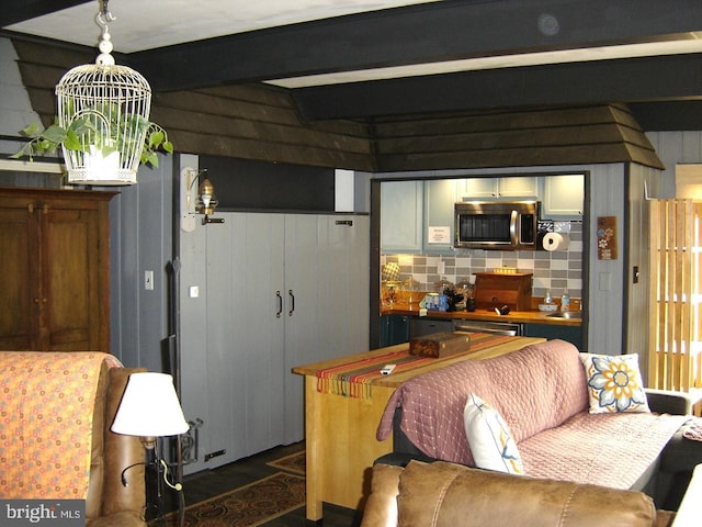 living room with beam ceiling