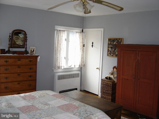 bedroom featuring radiator and ceiling fan