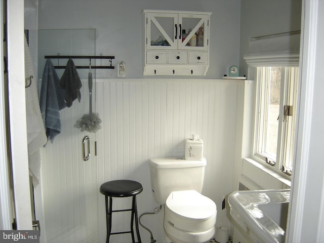 bathroom featuring wainscoting and toilet