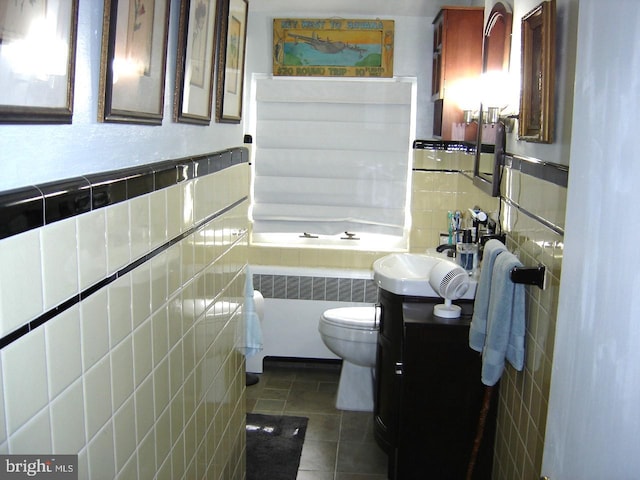 bathroom with tile walls, toilet, radiator heating unit, vanity, and tile patterned flooring