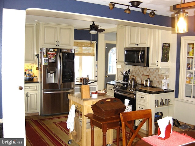 kitchen with stainless steel appliances, dark countertops, backsplash, glass insert cabinets, and ceiling fan