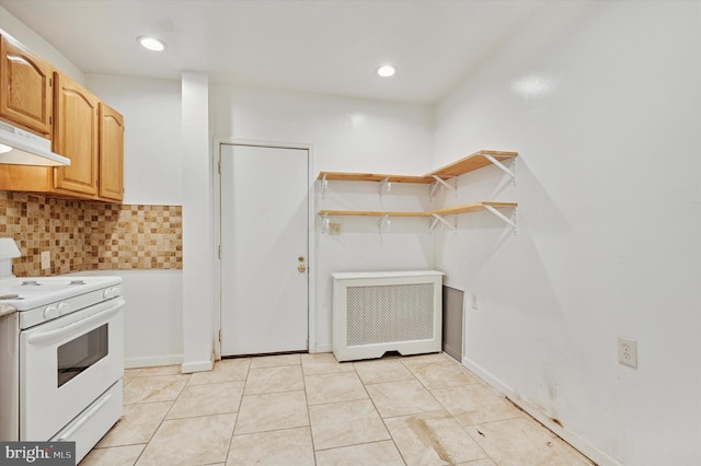 kitchen featuring tasteful backsplash, radiator heating unit, light countertops, under cabinet range hood, and white range with electric cooktop