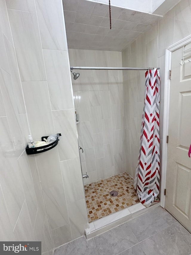 full bath featuring a shower stall and tile patterned floors