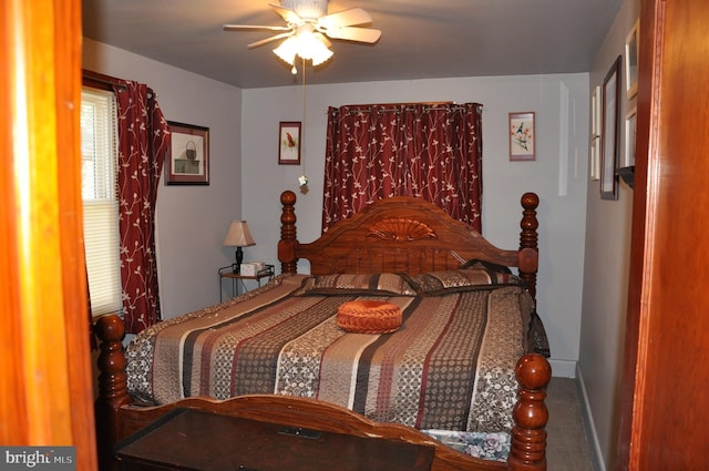 bedroom with ceiling fan and baseboards