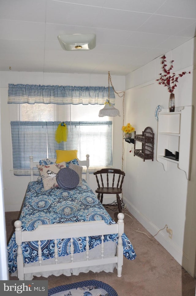 carpeted bedroom featuring baseboards