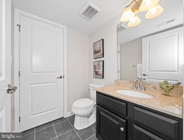 half bathroom featuring toilet, vanity, visible vents, and tile patterned floors