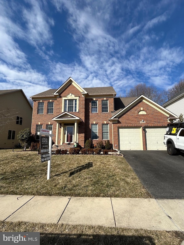 view of front of property with a garage, aphalt driveway, and brick siding