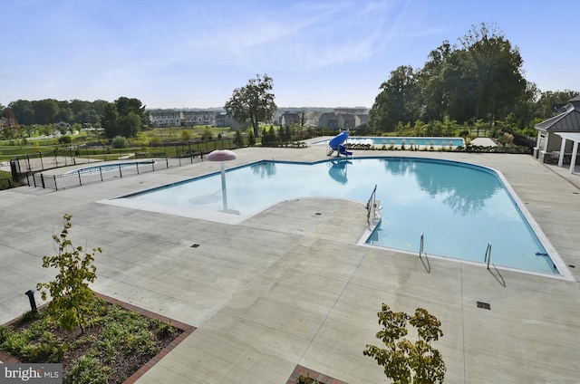 view of pool featuring a patio area, fence, and a fenced in pool