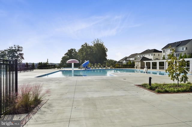 pool with fence and a patio