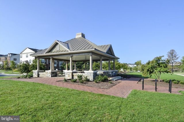 surrounding community with a gazebo and a lawn