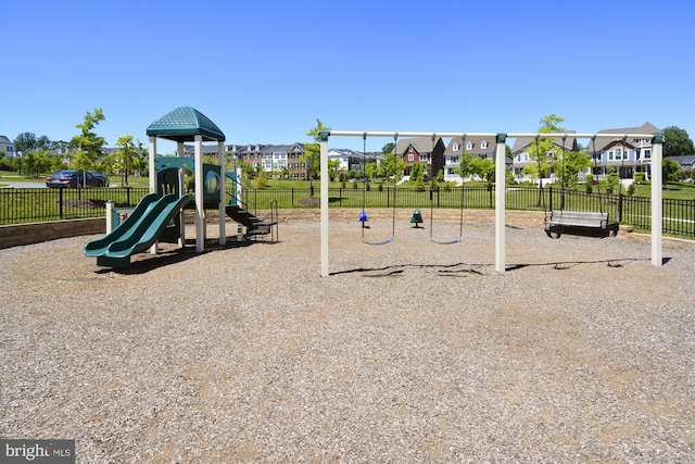 community jungle gym with fence and a residential view