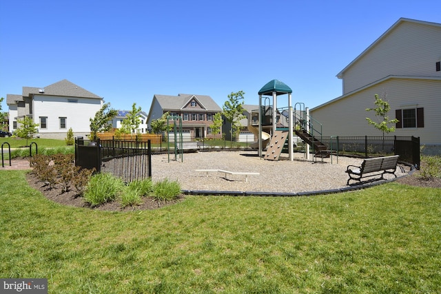 view of play area with a yard, a residential view, and fence