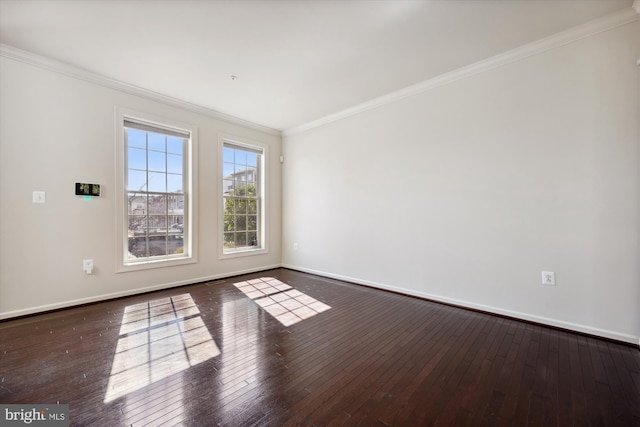 unfurnished room featuring dark wood-style flooring, crown molding, and baseboards