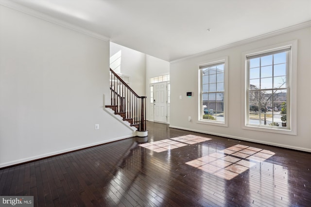 entrance foyer with ornamental molding, baseboards, stairway, and hardwood / wood-style floors