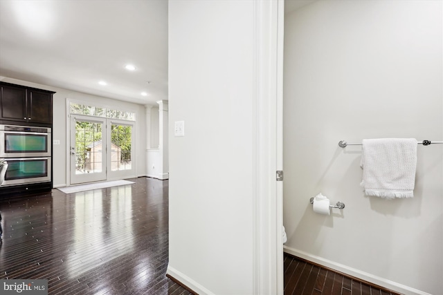 bathroom featuring ornate columns, baseboards, wood finished floors, and recessed lighting