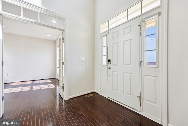 entryway with baseboards and dark wood finished floors