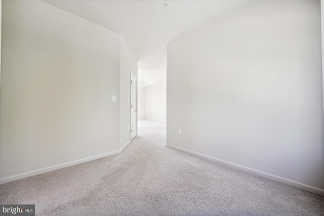 empty room with light colored carpet and baseboards