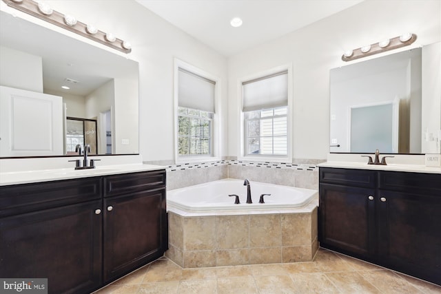 bathroom featuring two vanities, a sink, a bath, and a shower stall