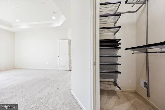 stairs featuring ornamental molding, carpet floors, a tray ceiling, and baseboards