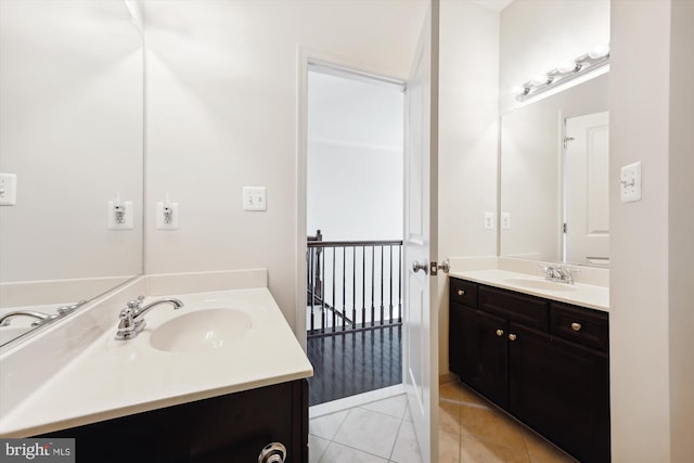 bathroom featuring two vanities, a sink, and tile patterned floors