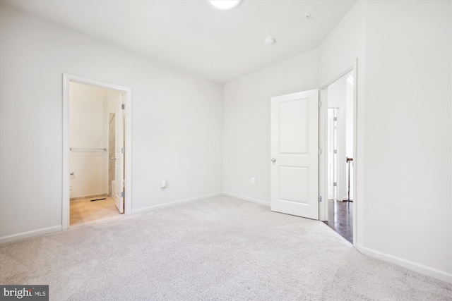 unfurnished bedroom featuring carpet and baseboards