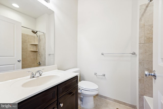 bathroom with baseboards, vanity, toilet, and tile patterned floors