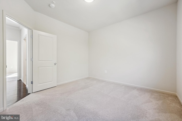 carpeted spare room with baseboards