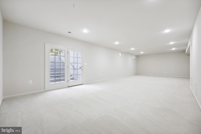 spare room with light carpet, baseboards, visible vents, and recessed lighting