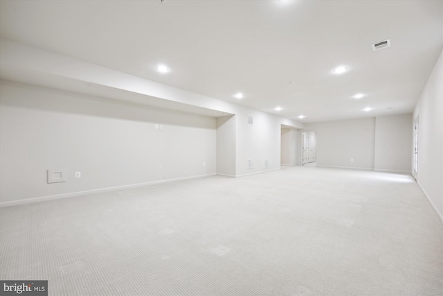 finished basement with light colored carpet, visible vents, and recessed lighting