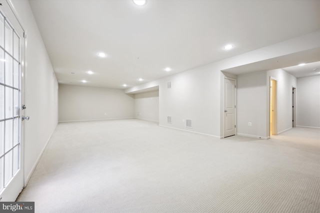 basement with light carpet, baseboards, and recessed lighting