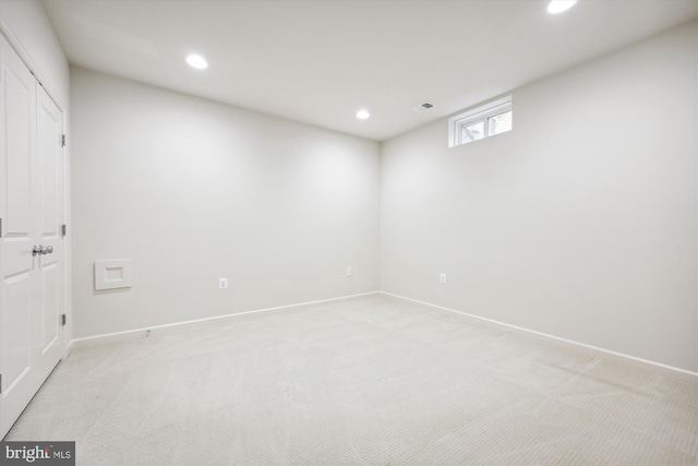 below grade area featuring recessed lighting, light colored carpet, and baseboards