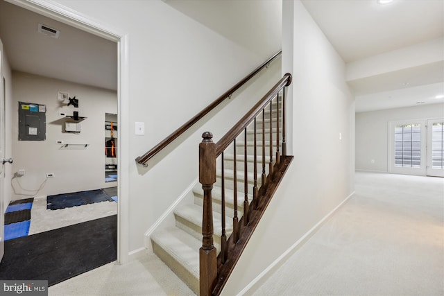 staircase with electric panel, carpet flooring, and baseboards