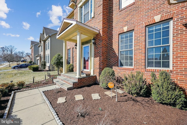 doorway to property with brick siding