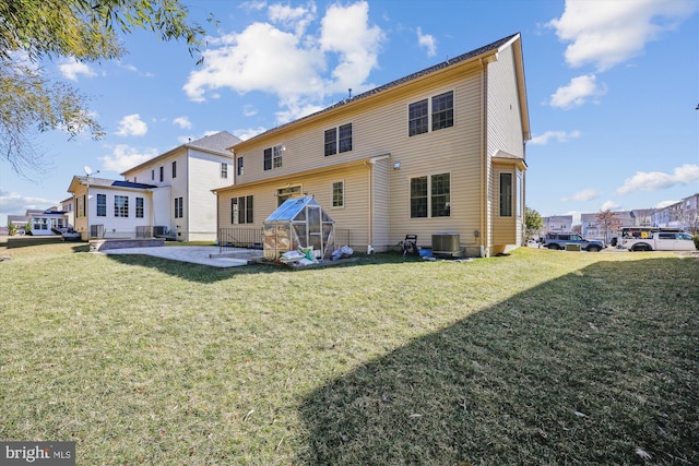 back of property featuring a yard, a patio area, and cooling unit