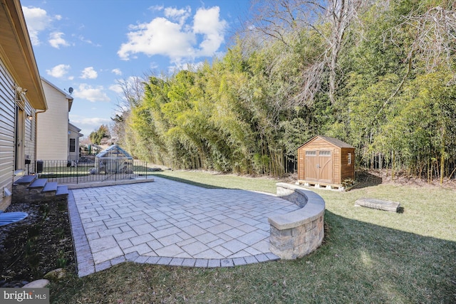 view of pool featuring a yard, a shed, an outdoor structure, and a patio