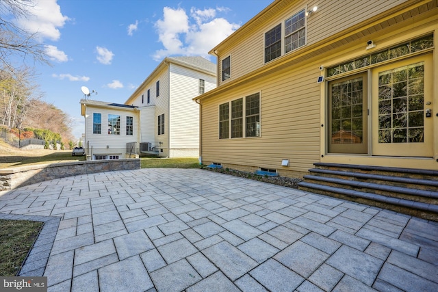 rear view of property featuring entry steps and a patio area