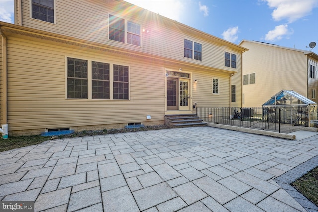 rear view of property featuring entry steps and a patio area