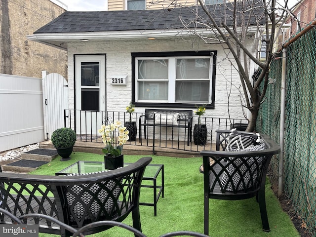 exterior space featuring a fenced front yard and a gate