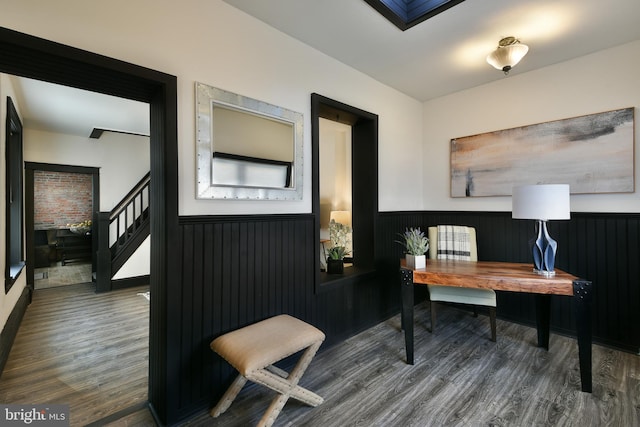 office with a wainscoted wall and dark wood-style flooring