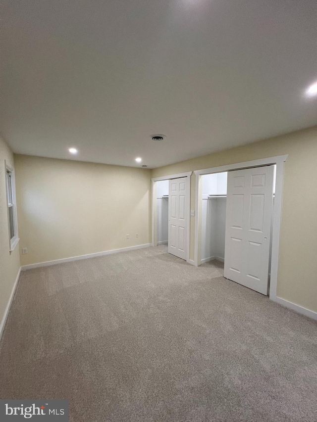 unfurnished bedroom with recessed lighting, light carpet, visible vents, and baseboards