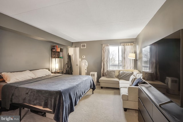 bedroom with light carpet and visible vents