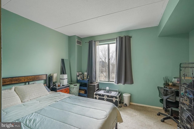 carpeted bedroom with a textured ceiling, visible vents, and baseboards